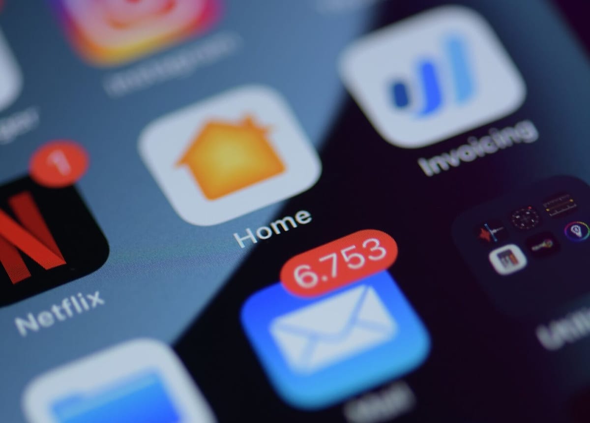 Close up of a mobile phone. The email app has 6,753 unread messages. Photo by Brian J. Tromp on Unsplash