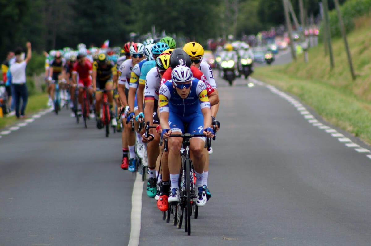 Cyclists in the Tour de France. Photo by Rob Wingate on Unsplash