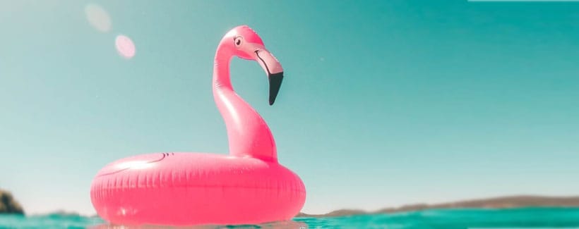 Inflatable pink flamingo, smiling, at sea! Photo by Vicko Mozara at unsplash.com/@vicko